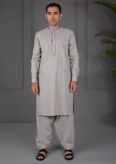 2 Piece - Kameez Shalwar : Be your classiest self in this sleek all-grey attire. Whether you’re on your way to a party or a family gathering, you're sure to look extra sharp! Details : Embroidered Front, Plain Back, Full Sleeves with Cuffs, Band Neckline, Plain Shalwar Color: Light Grey Fabric : Melange Textured fabric Country of Origin : Pakistan Care Instruction : Should be washed in gentle cycle and hung to dry. Color may bleed so please be mindful of other items with it. Disclaimer : Actual Gray Long Sleeve Wedding Set, Fitted Gray Sets For Eid, Fitted Gray Set For Festive Occasions, Festive Fitted Gray Set, Fitted Gray Sets For Festive Occasions, Traditional Gray Kurta For Wedding, Unstitched Semi-formal Festive Salwar Kameez, Fitted Salwar Kameez For Semi-formal Festive Occasions, Elegant Gray Kurta For Eid