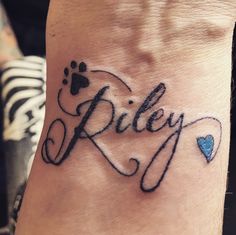 a person with a tattoo on their wrist has the word riley written in cursive writing