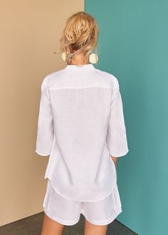 This Nyda tunic with textured pin-tuck details works a dream over your swim suit for lunch style with our Laura shorts or skin tight jeans for a beach side stroll. - 100% Italian "Masters of Linen"Pre-shrunkSoftened Classic White Shirt, Asymmetric Dress, Clothing Manufacturer, The Swing, White Shirts, Pin Tucks, Asymmetrical Dress, Small Tops, White Linen