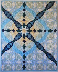 a blue and white quilt with an intricate design