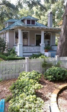 a white picket fence in front of a house