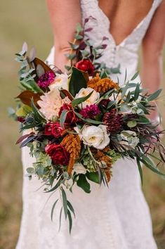 a bridal holding a bouquet of flowers and greenery