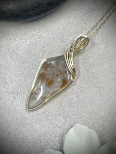 This wire wrapped pendant features a polka dot chalcedony cabochon wire wrapped in 14k gold filled wire. About the Pendant: - 100% handmade - Genuine polka dot chalcedony (moss chalcedony) - Non-tarnish 14k gold filled wire - Safe for daily wear - Suitable for those with metal allergies or sensitivities - One-of-a-kind piece A 14k gold filled chain will be included with the pendant.  The piece will ship in a pendant box and will include care instructions in the package.  The piece will be professionally polished prior to shipping so that it arrives sparkling and ready to wear. Our work is guaranteed!   - We offer repair services as well as intermittent polishing services at the buyer's request.  If you ever have an issue with your piece, let us know and we will make it right. - As our work Wire Wrapped Gemstone Jewelry, Wire Wrapped Crystal Pendant, Ethiopian Opal Jewelry, Schmuck Gold, Wire Wrapped Stone Jewelry, Chalcedony Necklace, Wire Wrapped Crystal, Bijoux Fil Aluminium, Wrapped Crystal