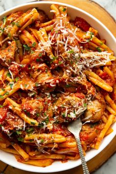 pasta with sauce and parmesan cheese in a bowl