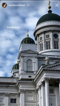 a large white building with two domes on top