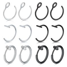 six pairs of stainless steel hoop earrings with black and white colors, all in different sizes