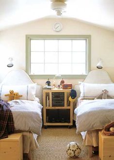 there are two beds in this room with toys on the nightstands and a soccer ball