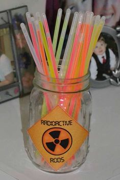 a glass jar filled with assorted colored straws