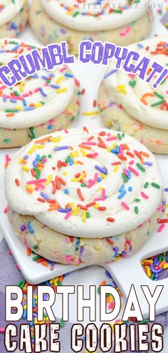 birthday cake cookies with white frosting and sprinkles are on a plate