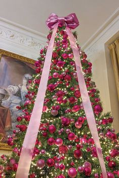 a decorated christmas tree with pink and red ornaments