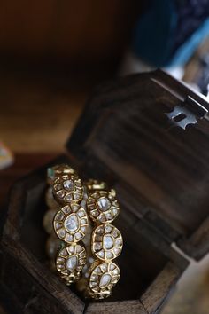 These bangles are a dream of a pair with such intricate details of uncut polki set on a silver alloy base and plated with 22k gold. A perfect arm candy for every age and occasion. Closure - Screw Style Tip - Elegance and royalty all packed in one with this gorgeous set of bangles. Pair this with anything and everything traditional Indian to lift up the vibe of the outfit. Handcrafted in Jammu and Kashmir Paisley Pop travels the depths of India to learn techniques and crafts from deep down the lo Bollywood Style Bracelets For Reception With Intricate Design, Bollywood Style Bracelets With Intricate Design For Receptions, Jeweled Bracelet Jewelry For Diwali, Silver Brass Bracelets For Wedding, Kundan Jewelry Bracelet For Reception, Silver Metal Bracelet With Stone Work, Bollywood Style Intricate Bracelets For Reception, Brass Bracelet Jewelry For Wedding, Brass Wedding Bracelet Jewelry