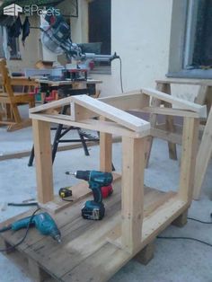 a work bench made out of wood with tools on it