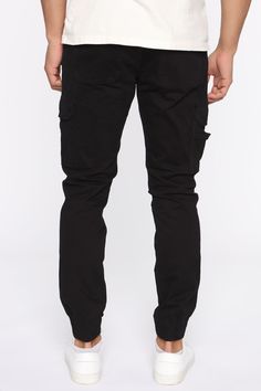 Available In Black, Khaki, Olive, Camouflage Button Closure Zip Fly Cargo Pants Elastic Hem 31 Inseam 98% Cotton 2% Spandex Imported | Mens Kryptonite Cargo Pants in Black size 32 by Fashion Nova Black Tapered Leg Cargo Work Pants, Black Tapered Leg Work Pants With Cargo Pockets, Black Cotton Cargo Style Joggers, Black Cotton Cargo Joggers, Black Tapered Leg Jeans With Cargo Pockets, Black Stretch Work Pants With Pockets, Black Cargo Pocket Tapered Leg Jeans, Stretch Black Work Pants With Pockets, Black Tapered Leg Cargo Jeans