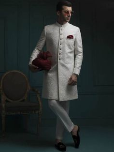 <p><strong>Sherwani:</strong><br />Color: Off-White<br />Fabric: Embroidered Raw Silk<br />Attractive plain white jamawar sherwani features rich quality<br />Fancy button closure</p> <p><strong>Inner:</strong><br />Complement with matching kurta and pajama</p> <p><br /><br /><strong>Additional Accessories:</strong> <br /><strong>Kolhapuri/Saleem Shahi shoes:</strong> US$30 (Made with sherwani material & embroidery) <br /><strong>Tied pre-made Turban:</strong> US$150 <br /><strong>Men's Plain Sha Sherwani Wedding, Velvet Kurta, Groom Sherwani, Mens Sherwani, Western Shoes, Wedding Sherwani, Fancy Buttons, Pakistani Designers, Sister Wedding