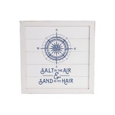 a white framed sign with a compass on it that says salt in the air and sand in my hair