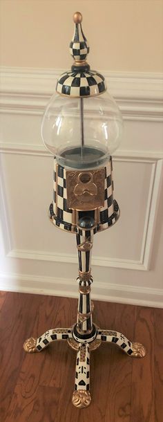 an old fashioned gumper machine on top of a wooden floor in front of a wall