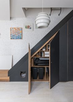 an open storage compartment under the stairs