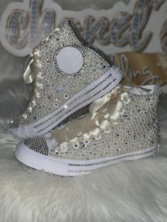 Custom Bling Converse All Star Chuck Taylor Sneakers. All designs handmade and embellished with a variety of high quality crystals. Great for weddings, proms, homecomings, birthdays, special events or just your everyday girly girl. **IF YOU NEED THIS ITEM BEFORE THE PROJECTED SHIPPING TIME YOU MUST CONTACT US BEFORE ORDERING (additional charges may apply) ** Shoe Details: Ivory high top Converse All Star Chuck Taylor Sneaker (Canvas Material) Shoe Size: Sizes stating at women's size 6 to women's Sparkly Converse, Quince Stuff, Bridal Sneakers, Bling Converse, Ribbon Shoes, Wedding Converse, Rhinestone Crafts, Jeweled Shoes, High Top Converse