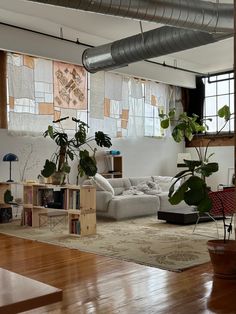 a living room filled with furniture and lots of plants