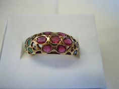 This ring contains 7 Rubies in a flower design in the center with 5 Emeralds on each side. The pierced work sets off the beauty of the ring. All stones are in good shape. The ring is in excellent condition. All stones are natural! The ring is a size 6. There are no markings on the ring. It tests 14K for sure or possibly higher. Thank you for viewing. Free Shipping USA Victorian Multi-stone Ruby Ring For Anniversary, Victorian Multi-stone Ruby Ring, Antique Yellow Gold Multi-stone Ruby Ring, Antique Multi-stone Ruby Ring In Yellow Gold, Vintage Ruby Multi-stone Rings, Antique 14k Gold Ruby Ring With Multi-stone, Heirloom Multi-stone Ruby Ring For Formal Events, Antique Ruby Ring With Multi-stone, Antique Multi-stone Round Emerald Ring