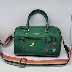 Brand: Coach Style: Rowan Satchel With Diary Embroidery / C8280 Condition: New With Tag Exterior Color: Green Multi Exterior Features: Front Zipper Pocket Interior Features: Inside Zip And Multifunction Pockets Closure: Zipper Hardware Color: Gold Straps: Two Short Handles And One Crossbody Strap Official Measurements: 10.5" L X 6.25" H X 5.5" W Includes: Coach Hangtag No Lowball Offers Or Trades Please. Thank You For Looking! Green Bag With Embroidered Logo For Everyday Use, Green Coach Satchel For Daily Use, Luxury Embroidered Green Bag, Luxury Green Embroidered Bag, Coach Green Satchel With Removable Pouch, Coach Green Top Handle Satchel, Green Coach Satchel With Removable Pouch, Green Coach Satchel With Detachable Handle, Green Coach Top Handle Satchel