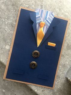 a card made to look like a suit and tie with buttons on the lapel