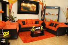 a living room with orange and black furniture