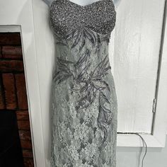 This Lace Dress Has A Beaded Sweetheart Neckline, And Beaded Leaf Detail Over The Lace Throughout The Front And Back Of The Dress. Perfect For A Wedding Guest Or Any Event. New With Tags. Never Worn. Never Altered. Excellent Condition. Kept In Shop Clear Zippered Bag. Formal Embellished Dress With Sweetheart Neckline, Fitted Sequin Dress With Rhinestones And Sweetheart Neckline, Sleeveless Beaded Dress With Fitted Bodice, Beaded Sleeveless Dress With Fitted Bodice, Embellished Sleeveless Sequin Lace Dress, Sleeveless Embellished Sequin Lace Dress, Lace Evening Dress With Embellished Fitted Bodice, Glamorous Beaded Dress With Sweetheart Neckline, Elegant Sequin Dress With Rhinestones And Sweetheart Neckline