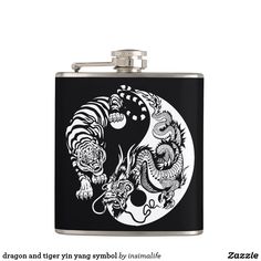 a dragon and tiger yin symbol on a black flask