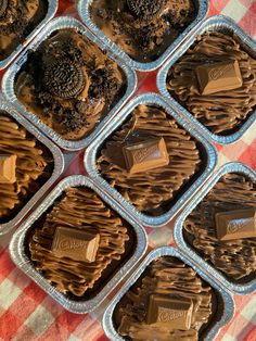 chocolate desserts in tins sitting on a checkered tablecloth