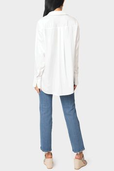 The white shirt has got a new look for the season with details that make this perfect for every look. This chic and easy button-front blouse in our satin effect fabric has 5 ways to wear. Open or closed, layered over a simple tee with leggings, front-tied for creating the look of the season, casually front-tuck one side for the perfect day-look with denim, or tucked in for an elevated wear-to-work look. 62% Polyester | 38% Rayon Delicate Wash Cycle, Dry Flat. Length 26 1/2" (size small) Front Bu Versatile White Blouse With Button Closure, White Versatile Blouse With Button Closure, Chic Blouse For Layering With Shirttail Hem, Elegant Blouse With Shirttail Hem For Layering, Relaxed Fit Blouse With Button Closure For Layering, Classic Blouse With Button Cuffs For Layering, Blouse With Button Closure And Shirttail Hem, Button-up Blouse For Layering, Chic Button-up Tops For Layering