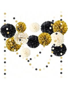 black, white and gold pom poms hanging from a string on a wall