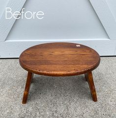 a small wooden table sitting in front of a garage door with the words before written on it