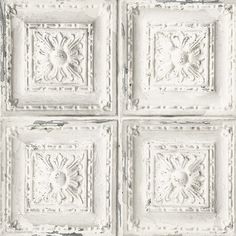 four square white tiles with decorative designs on the top and bottom, all in different sizes