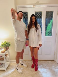 a man and woman standing in front of a door