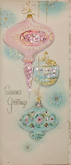 a christmas card with ornaments hanging from it's sides and the words season's greetings written below