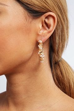 Make a statement with the Brielle Pearl Hoop Earrings, where bold design meets classic elegance. Handcrafted with artisanal skill, these earrings feature luminous pearls nestled within gleaming golden hoops, creating a striking contrast of textures and shapes. Perfect for adding a touch of drama to everyday looks or for complementing evening attire, they are a versatile must-have for the modern woman's jewelry collection. Pair them with sleek updos and off-shoulder dresses for a look that comman Sleek Updo, Golden Hoops, Off Shoulder Dresses, Pearl Hoop Earrings, Classic Elegance, Cultured Pearls, Modern Woman, Everyday Look, Timeless Elegance