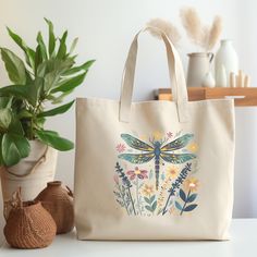 This farmers market-style canvas tote is a great for every day use or as a gift for someone special. You can use it for a trip to the market or for your day at the spa or Yoga studio.  We use a high quality professional direct to garment (DTG) process on our products, this means fabric-grade ink is printed directly onto the garment blending with the fibers. This process allows us to achieve a vintage style look on many of our designs, and a feel that is similar to screen-printing (which avoids the thick rubbery feeling of vinyl). Machine wash cold inside-out with similar colors and by using a color-safe detergent. This spacious tote bag will be the best companion on weekly shopping trips, day trips and beach days. It's made from a natural, 10oz./yd² cotton canvas fabric that is extremely d Casual Canvas Bag For Gift, Rectangular Canvas Bag For Gift, Daily Use Canvas Bag With Eco-friendly Ink, Everyday Canvas Bag For Mother's Day, Eco-friendly Canvas Bag For Gifts, Bohemian Everyday Canvas Gift Bag, Eco-friendly Ink Canvas Bag Gift, Eco Friendly Shopping Bags, Cottage Core Aesthetic