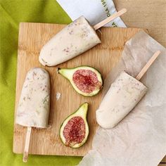 figs and cheese are sitting on a cutting board