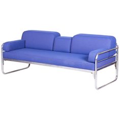 a blue couch sitting on top of a metal frame