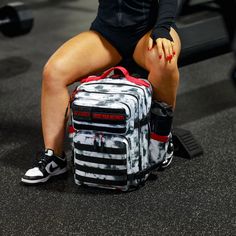 a woman sitting on top of a gym bag