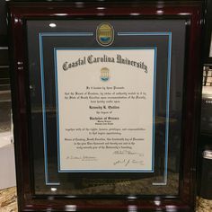 a framed diploma is on display at the university's graduation ceremony in this case