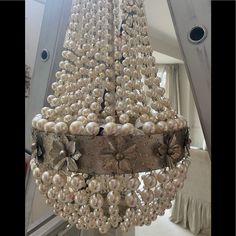 a chandelier with pearls hanging from it's sides