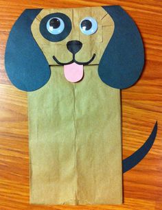 a brown paper bag with a dog on it's face and eyes cut out