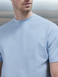 Arguably the most essential piece of any wardrobe, upgrade the classic tee with a smooth touch interlock blend fabric. A slim fit and crew round neckline flatters any style of outfit. Wear with trousers and a relaxed blazer for a too-cool-for-school look. Slim fit Round crew neckline Short set-in sleeves Stitched trims on sleeve & hem Tonal embroidered branding on back neck 4-way stretch luxury fabric Smooth touch Made in Portugal This piece fits true to size, however for a looser fit select a s Relaxed Blazer, Wardrobe Upgrade, Luxury Fabric, School Looks, Short Set, Luxury Fabrics, Short Sets, Crew Neckline, Fabric Material