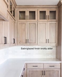 a kitchen with white counter tops and wooden cabinets in the background, there is no image here to provide a caption for