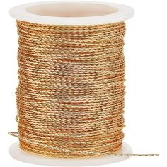 a spool of gold colored rope on a white background