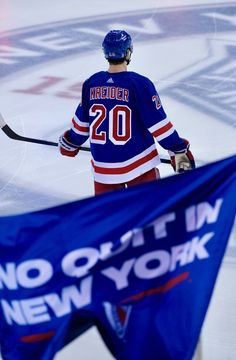 a hockey player is holding his stick and wearing a blue jersey with the number 20 on it