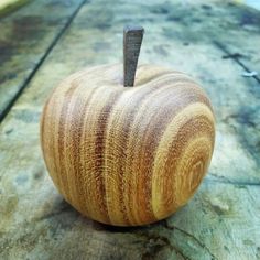 a wooden apple sitting on top of a table