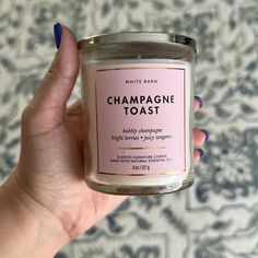 a hand holding a candle that says champagne toast